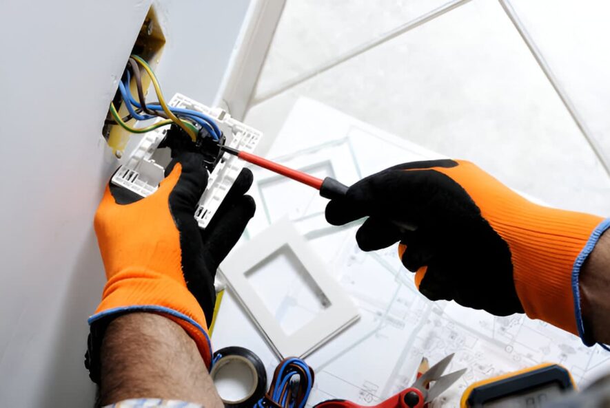 two hands with globes working on a TV mount Installation in sydney