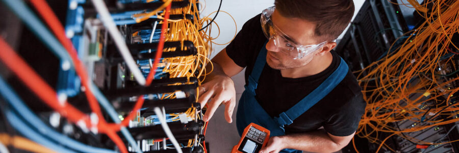 a professional electrician working on a data cabling board for a tech company in a Sydney office