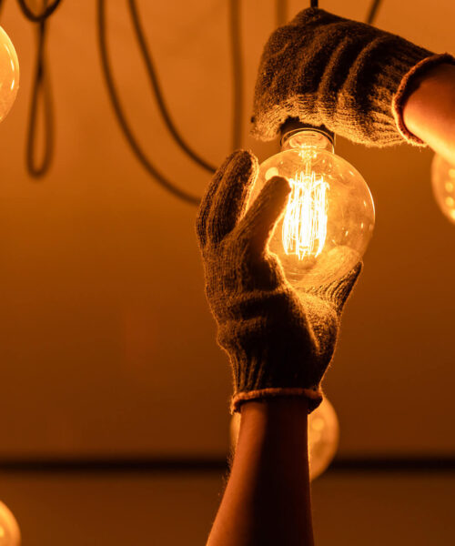 an electrician working on a dimmer switch with an electric cotton cable