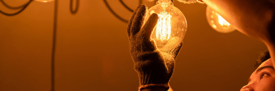 an electrician working on a dimmer switch with an electric cotton cable